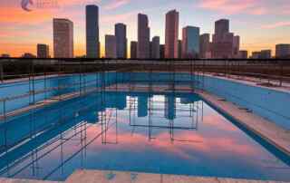 A skyline of the city of Houston with a permitted swimming pool being on built